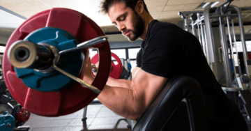 man doing preacher curls exercise