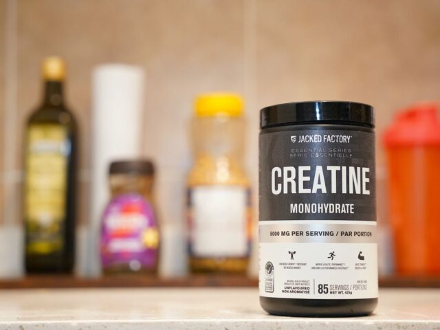 A container labeled creatine monohydrate on a kitchen counter.